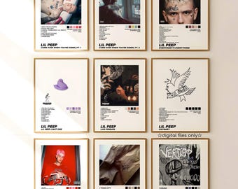 May include: Nine framed art prints showcasing Lil Peep album art and portraits. Each print has a distinct colour scheme and design, with text including album titles and track listings. The prints are displayed on a white wall, creating a gallery-like presentation.
