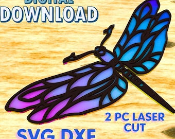 May include: A digital download of a two-piece laser cut dragonfly design in SVG and DXF formats. The dragonfly is blue, purple, and black with intricate details.