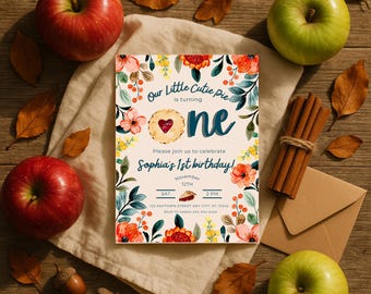 May include: A birthday invitation with floral and leaf accents, featuring the text "Our Little Cutie Pie is turning one." Red and green apples, cinnamon sticks, and autumn leaves surround the invitation. The invitation is for Sophia's 1st birthday.
