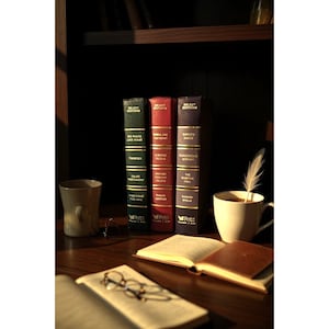 May include: A still life featuring three vintage books with gold lettering and a cup of coffee with a feather. The books are in shades of green, red, and purple. An open book and eyeglasses are in the foreground.