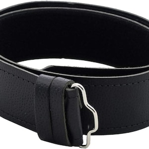 May include: A black leather belt with a silver buckle. The belt is textured and has a stitched edge.