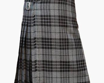 May include: A grey and black tartan kilt with two leather straps and buckles. The kilt has a pleated design and a fringed edge. The traditional Scottish garment is made of a woven fabric.