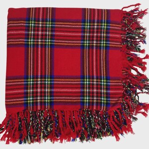 May include: Red plaid throw blanket with fringe on all sides. The blanket is made of a soft, woven fabric.