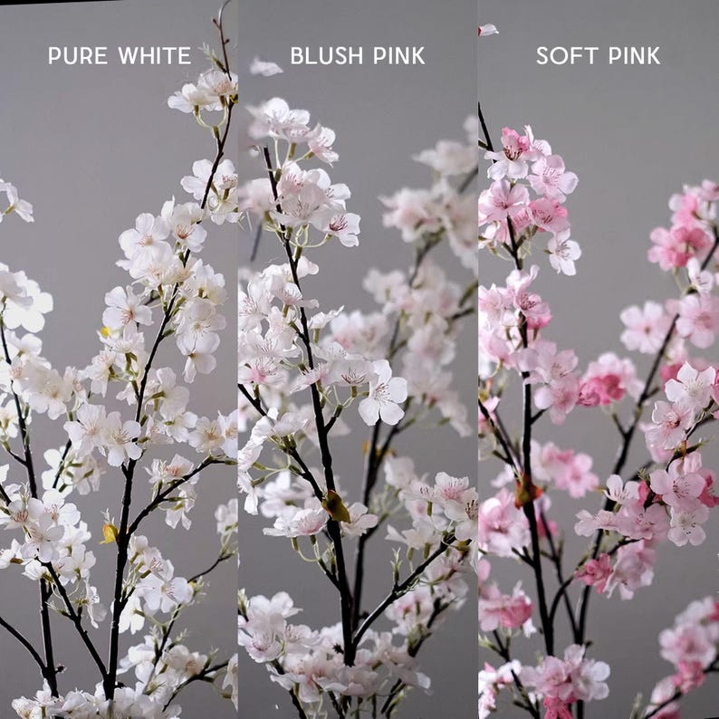 May include: Branches of artificial cherry blossoms in three color variations: pure white, blush pink, and soft pink. The flowers are in full bloom, with delicate petals and dark brown stems. The background is a neutral gray.