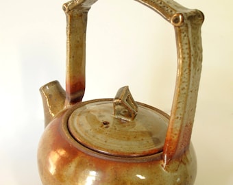 Contemporary stoneware teapot with unique bottom design. Fully functional conversation piece!