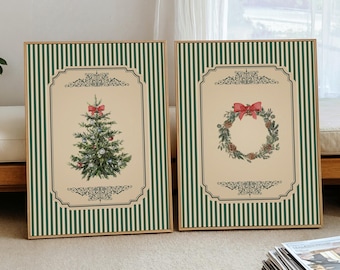 May include: Two framed Christmas art prints. One features a Christmas tree with a red bow, the other a wreath with a red bow. Both have a cream background with green striped borders and ornate detailing.