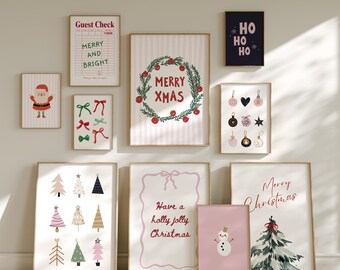 May include: A collection of framed Christmas-themed art prints. The prints feature festive designs like Santa Claus, Christmas trees, ornaments, and holiday greetings such as "Merry Xmas" and "Merry Christmas". The color palette includes red, green, pink, and gold.