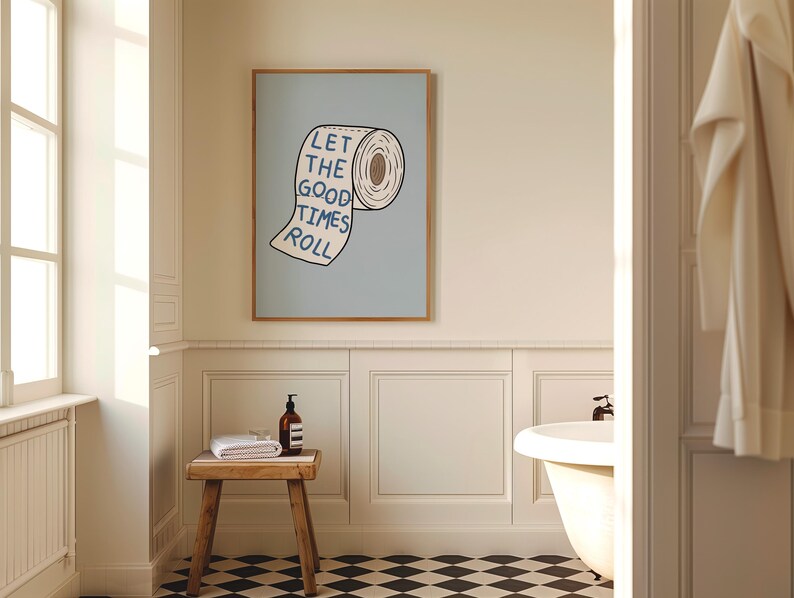 Illustrated toilet paper wall art with the phrase “Let the Good Times Roll” in blue lettering on a soft blue background, designed as playful bathroom decor.