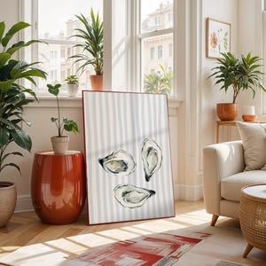oyster print, coastal kitchen decor, watercolor seafood, preppy wall art, a watercolor painting of three oysters on the half shell, artfully arranged on a background of light blue and white vertical stripes, perfect for a beach house or kitchen.