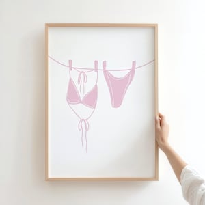 coastal cowgirl decor, pink wall art set, how lucky are we, preppy prints, a gallery wall set of three framed prints in a pink, coastal cowgirl style: one with a bikini on a clothesline, one with the quote 'How lucky are we?' on a striped background, and one with a pair of pink cowboy boots.