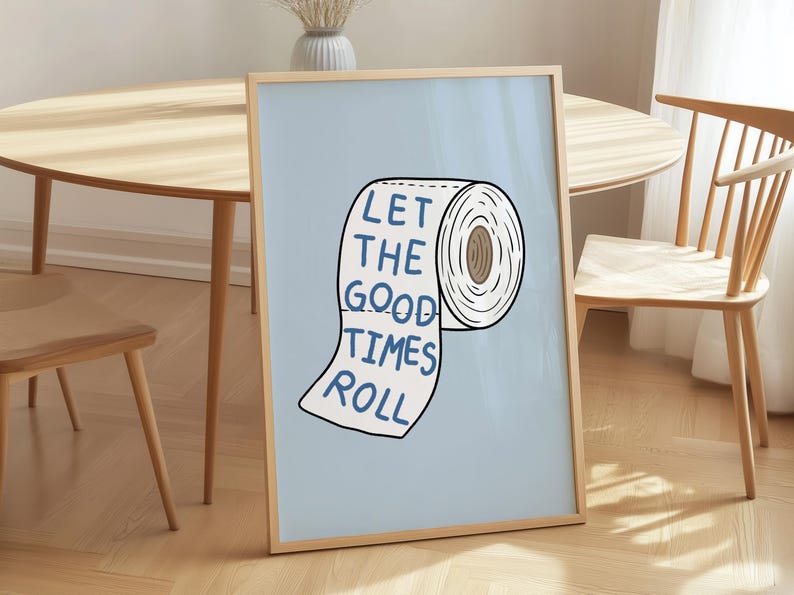 Illustrated toilet paper wall art with the phrase “Let the Good Times Roll” in blue lettering on a soft blue background, designed as playful bathroom decor.