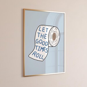 Illustrated toilet paper wall art with the phrase “Let the Good Times Roll” in blue lettering on a soft blue background, designed as playful bathroom decor.