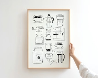 May include: A framed black and white illustration of coffee-related items. The artwork includes a coffee cup, a moka pot, a coffee grinder, a French press, and a bag of coffee beans. The frame is a light brown color.