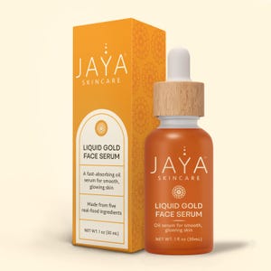 May include: An orange bottle of Jaya Skincare Liquid Gold Face Serum with a wooden cap and dropper, next to a matching box. The box and bottle feature the Jaya Skincare logo and product information. The serum is 1 fl oz (30 mL).