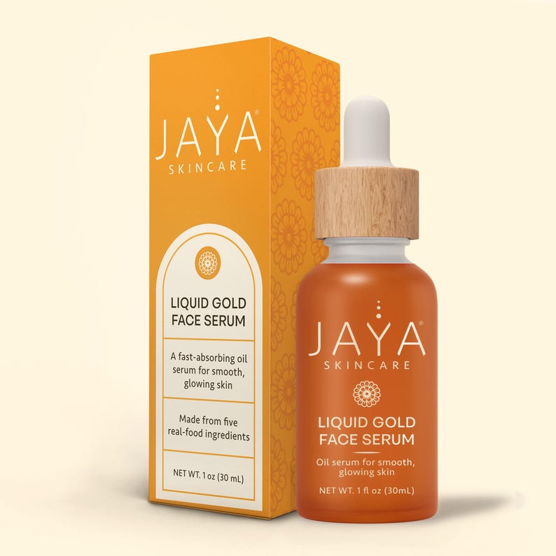 May include: An orange bottle of Jaya Skincare Liquid Gold Face Serum with a wooden cap and dropper, next to a matching box. The box and bottle feature the Jaya Skincare logo and product information. The serum is 1 fl oz (30 mL).