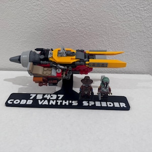 May include: A white ceramic mug with a black handle and the text "But First, Coffee" in a handwritten style. The mug is on a white surface. The mug is approximately 10 cm tall.