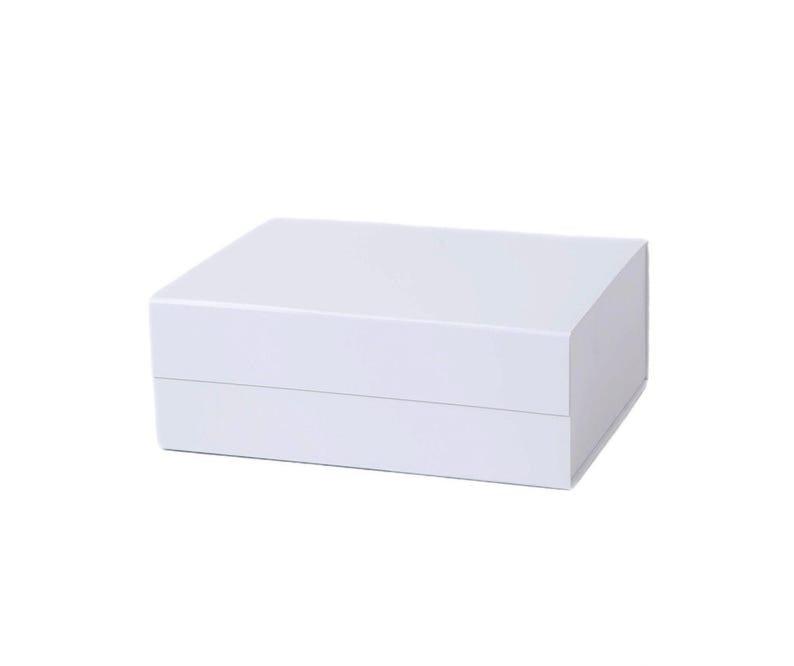 May include: A white, rectangular box with a lid. The box is made of a smooth, solid material and has a clean, minimalist design. The box is likely used for storage or packaging.