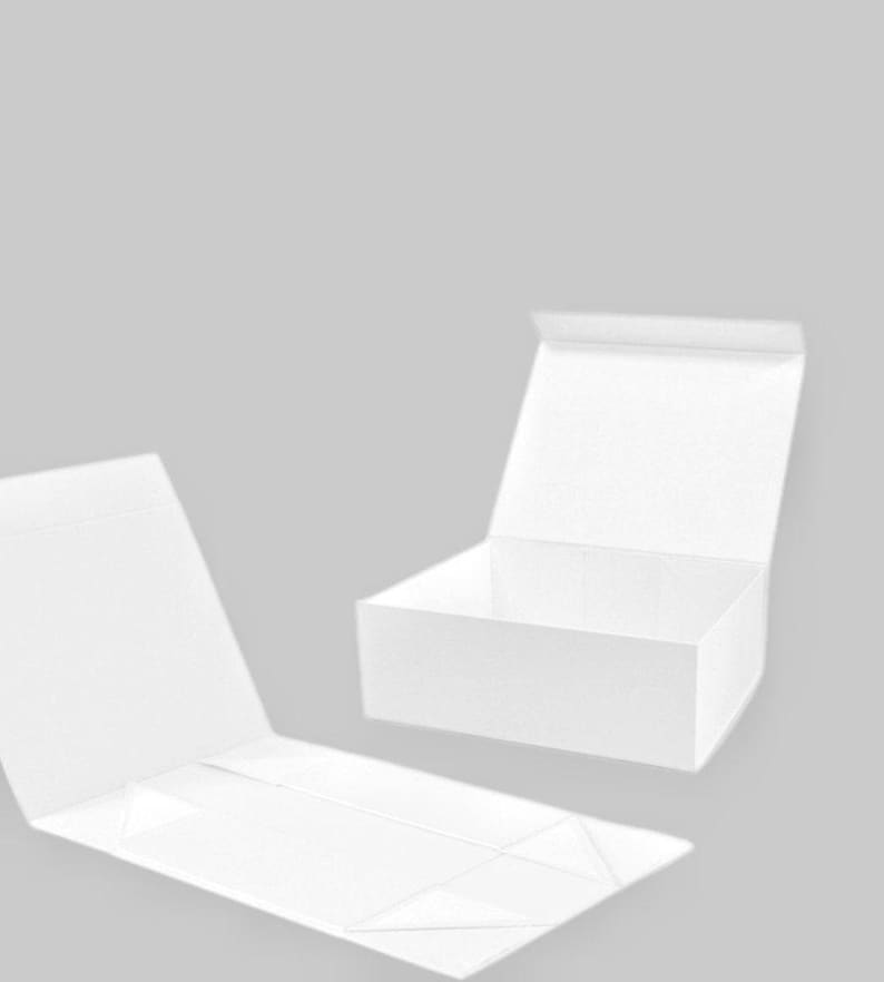 May include: White, foldable gift boxes. One box is open, revealing the interior, while another is partially open, and the third is flat. The boxes are made of a textured material and are set against a light gray background.