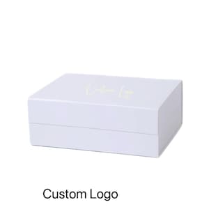 May include: A white rectangular box with a lid. The words "Custom Logo" are printed on the top in a light green color. The text "Custom Logo" is printed at the bottom of the box.