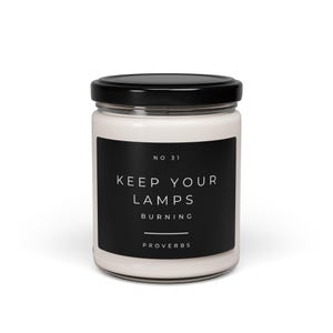May include: A white candle jar with a black label that reads "NO. 31 KEEP YOUR LAMPS BURNING PROVERBS".