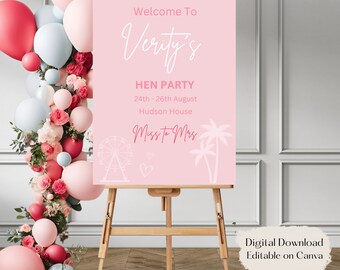Puede incluir: Un cartel de bienvenida rosa con el texto "Welcome To Verity's HEN PARTY 24th - 26th August Hudson House Miss to Mrs" con una noria blanca y palmeras. El cartel está en un caballete con una guirnalda de globos rosas y azules detrás. El texto "Digital Download Editable on Canva" está en la parte inferior de la imagen.