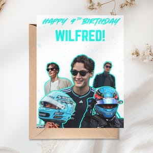 May include: Birthday card with a photo of a man wearing sunglasses and a racing helmet. The card has the text "HAPPY 9TH BIRTHDAY WILFRED!" in turquoise. The card is on a brown envelope.