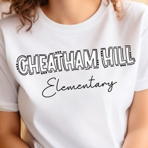 May include: White t-shirt with black text that reads "Cheatham Hill Elementary" in a stylized font.