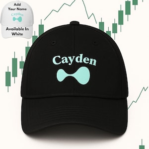 May include: Black baseball cap with the name "Cayden" in light blue, along with a matching abstract design. The cap is available in white, as indicated in the upper left corner. The background features a chart.