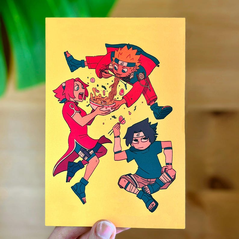 May include: A yellow background with three cartoon characters. A red-haired girl holds a bowl of ramen noodles. A boy with black hair and a green shirt sits with chopsticks. A boy with orange hair and a red shirt is upside down, eating noodles.