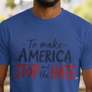 May include: A royal blue short-sleeved t-shirt featuring the text To make AMERICA STOP the HATE in a mix of black and red lettering. The word AMERICA is in large black font, while STOP and HATE are in large red font with smaller text.