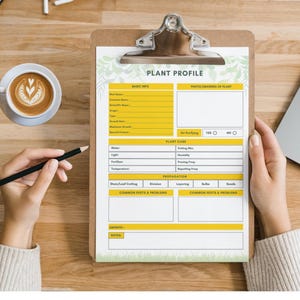 May include: A clipboard with a "PLANT PROFILE" form, held by a person. The form has sections for basic info, plant care, and propagation. A cup of coffee and a laptop are on the wooden surface. A pencil is held near the form.