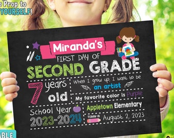 May include: A personalized first day of school sign with a chalkboard background. The sign features a girl holding a paintbrush and a paint palette. The sign says "Miranda's First Day of Second Grade" and includes the child's age, favorite color, and school year. The sign is available in multiple sizes.