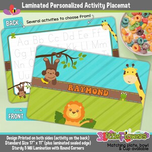 May include: A laminated personalized activity placemat with a jungle theme. The front features a lion, a giraffe, and a frog. The back has a monkey and a tracing alphabet activity. The placemat is 17 inches by 11 inches and has rounded corners. The text "RAYMOND" is printed on the front of the placemat.