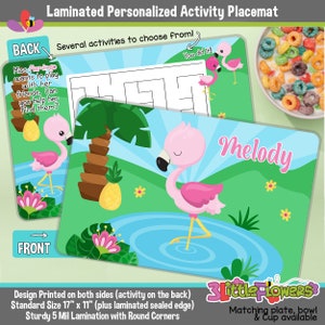 May include: A pink flamingo placemat with a blue lake and green grass. The placemat has the name "Melody" printed on it. The back of the placemat has a maze activity with a pink flamingo. The placemat is 17 inches by 11 inches and is laminated with rounded corners.