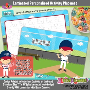May include: A laminated personalized activity placemat featuring a baseball theme. The front side shows a cartoon baseball player with the name "Derek" on a baseball field. The back side has a tracing activity for letters of the alphabet. The placemat is 17 inches by 11 inches and has rounded corners.