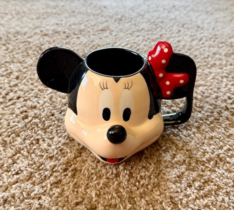 May include: A set of three ceramic mugs with a speckled, matte finish. The mugs are in shades of cream, light gray, and dark gray. Each mug has a simple, minimalist design, perfect for coffee or tea.