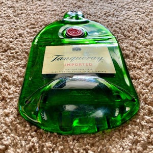 May include: A green glass bottle with a Tanqueray Imported label. The bottle is made from the world's finest botanicals and is distilled four times.