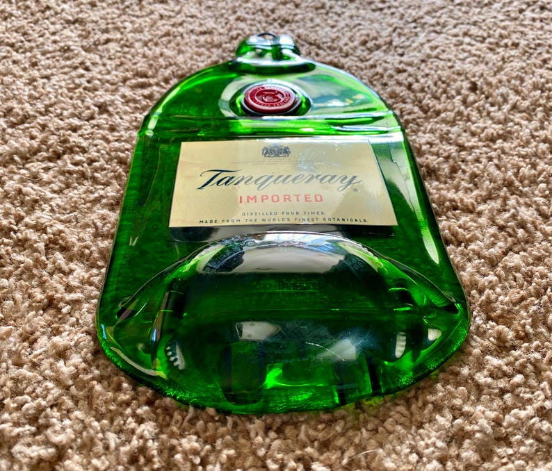 May include: A green glass bottle with a Tanqueray Imported label. The bottle is made from the world's finest botanicals and is distilled four times.
