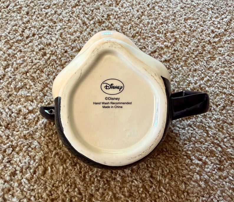 May include: A set of three ceramic mugs with a speckled, matte finish. The mugs are in shades of cream, light gray, and dark gray. Each mug has a simple, minimalist design and a rounded handle.