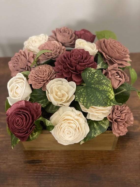 Beautiful hand dyed sola wood flowers in burgundy, mauve and white arranged in a charming brown box.