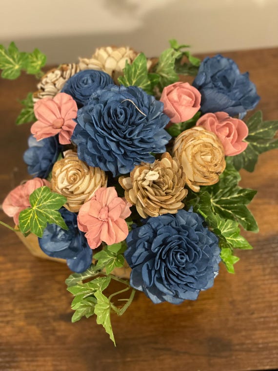 Bright blue and pink Sola Wood flowers in a wooden box.