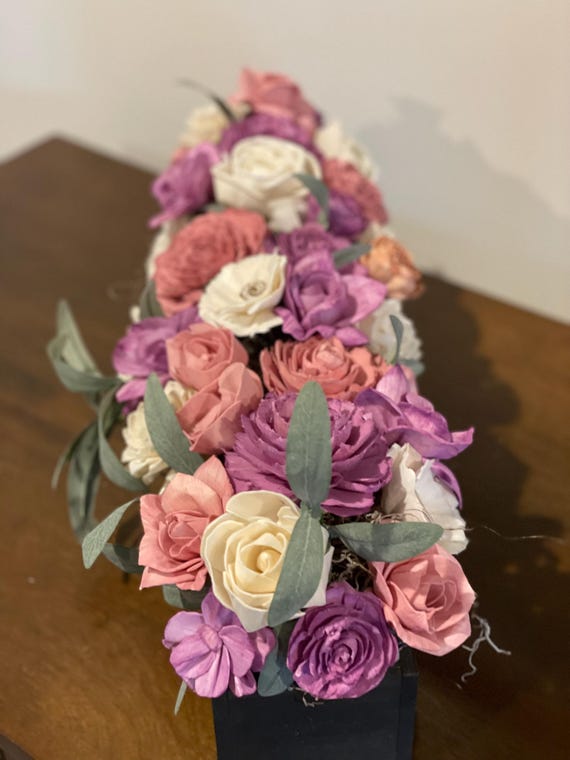 Beautiful sola wood flowers hand painted wood flowers in purple, lavender, mauve and white arranged in a black wooden box.