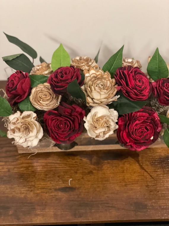 Beautiful red and barked Sola Wood flowers in a library box