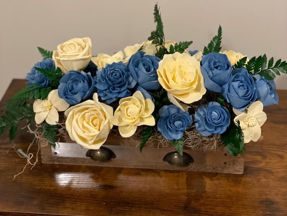 Hand-painted blue and yellow sola wood flowers beautifully arranged in a library box. A perfect addition to any room!