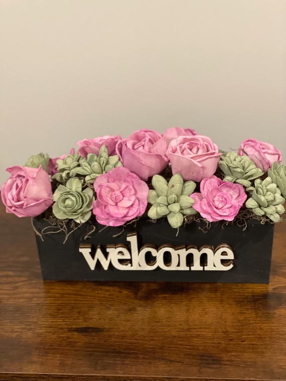 Pretty in pink! This beautiful Sola Wood flowers are beautiful pink and sage in a black wooden container.