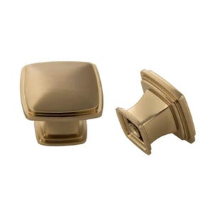 May include: Two gold square cabinet knobs with a brushed finish. The knobs have a square base and a raised square top.