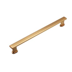 May include: A gold-toned cabinet pull with a rectangular shape and a smooth, brushed finish. The pull is approximately 6 inches long.