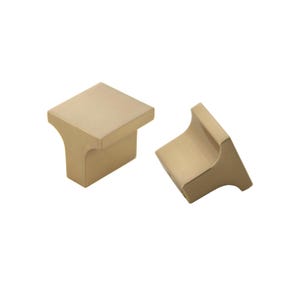 May include: Two brushed gold cabinet knobs with a square top and a T-shaped base.