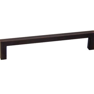 May include: A dark bronze cabinet pull with a rectangular shape and a square end.