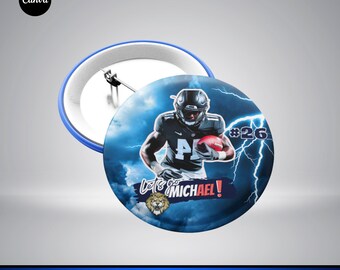 May include: A blue and white sports team pin button design featuring a football player in a blue jersey with the number 26 on it. The player is holding a football and running with a determined expression. The background is a blue and white cloudy sky with lightning bolts. The text "Let's go MICHAEL!" is written in white on a blue banner. A lion's head is visible in the lower left corner.